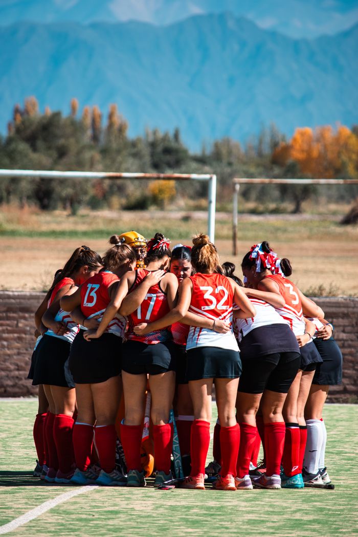 The Art of Drawing Readers In: Your attractive post title goes here Women's field hockey team huddled on a field with mountain view.